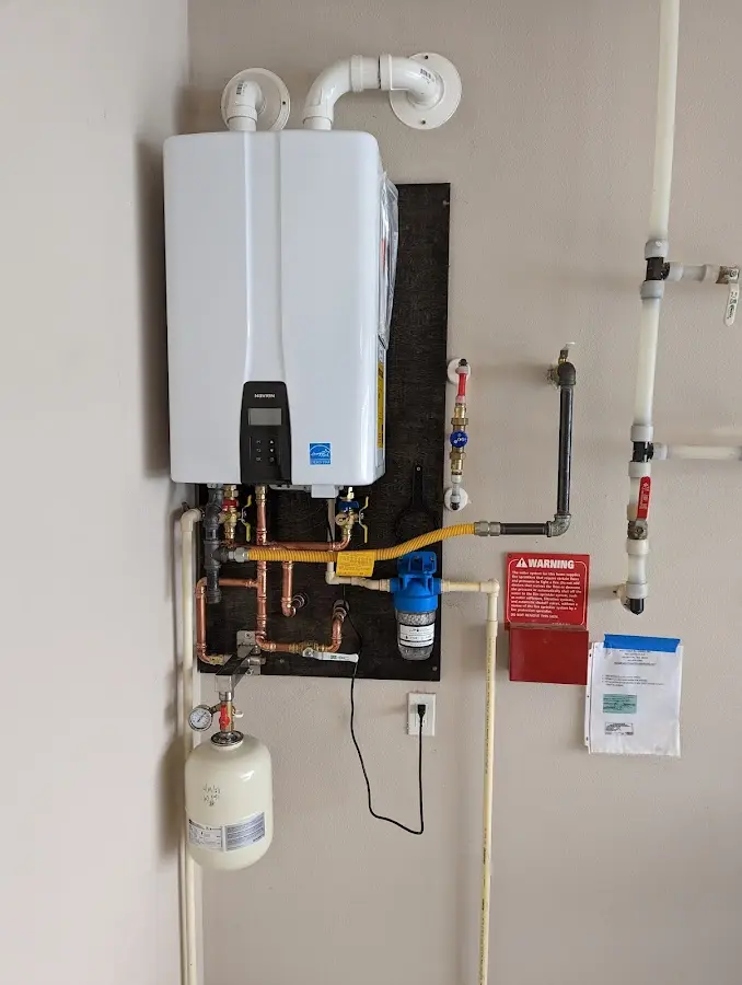 Professional plumber installing copper piping in a Forsyth home